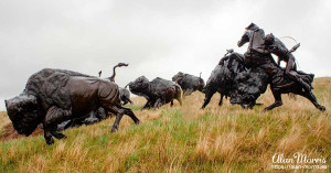 Bronze statue of Lakota Indians hunting Bison at Tatanka.