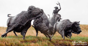 Bronze statue of a Lakota Indian hunting a bison at Tatanka, Story of the Bison.