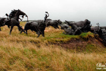Bronze statue of a Lakota Indian hunting a bison at Tatanka, Story of the Bison.
