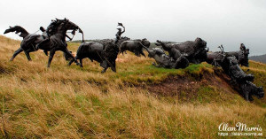 Bronze statue of a Lakota Indian hunting a bison at Tatanka, Story of the Bison.