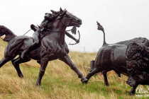 Bronze statue of a Lakota Indian hunting a Bison.