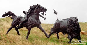 Bronze statue of a Lakota Indian hunting a Bison.