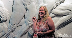 Tracy Good next to a stone relief. Tracy Good next to a stone relief.