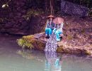 Two girls from the Tribe of the Three Gorges wash clothes in the Xiangxi River