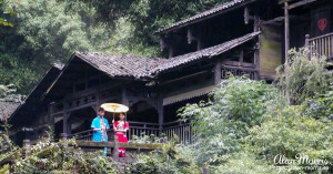A boy playing an instrument with a girl holding an umbrella above them. A boy playing an instrument with a girl holding an umbrella above them.