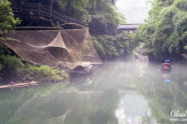 Mist hovers over the Xiangxi River in the Xiling Gorge