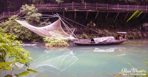 Fishing nets hang between fishing boats on the Xiangxi River in the Xiling Gorge.