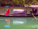 Girl from the Tribe of the Three Gorges, sitting on a boat.