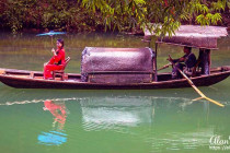 Girl from the Tribe of the Three Gorges, sitting on a boat.