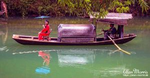 Girl from the Tribe of the Three Gorges, sitting on a boat.