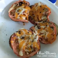Potato with slice of tomato and a pinch of cheese.
