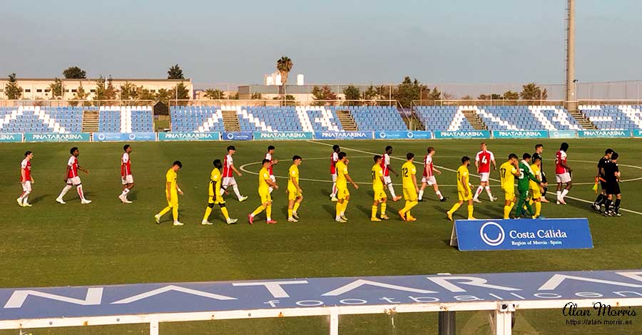 Arsenal & Villa Real teams walk onto the pitch at Pinatar Arena.